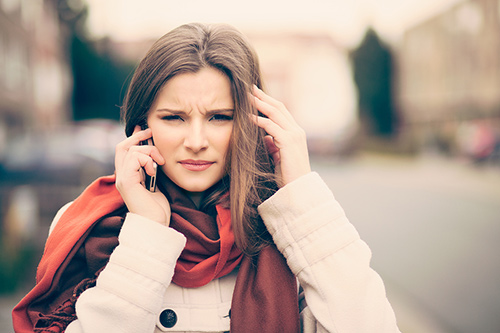 woman-with-phone-headache-500px.jpg