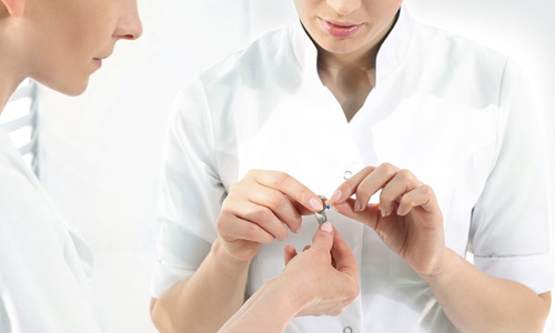 audiologist-working-with-hearing-aid.jpg
