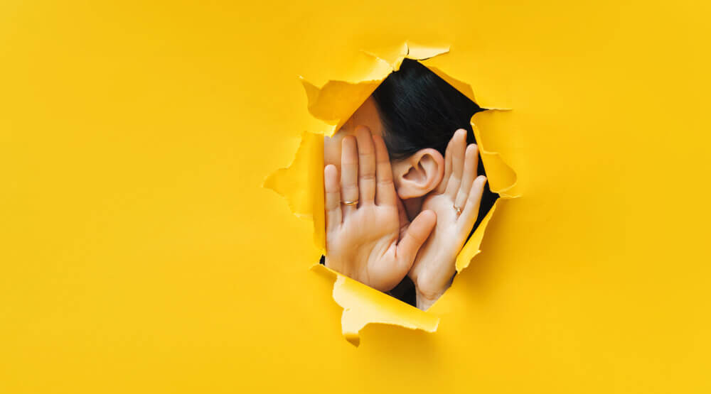 women-ear-through-cardboard.jpg