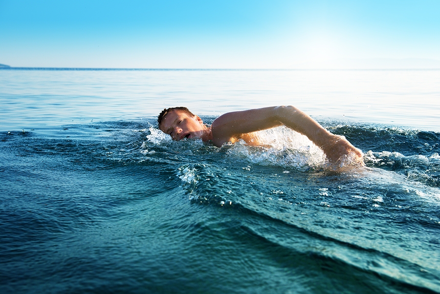 bigstock-young-man-swimming-in-oceans-w-12752129.jpg
