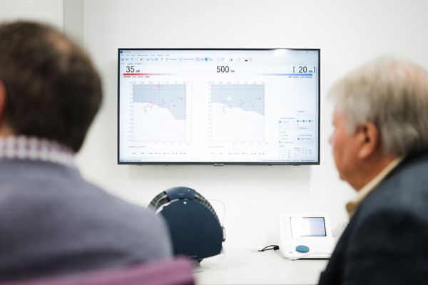christchurch audiologist discussing an audiogram after hearing test.jpg