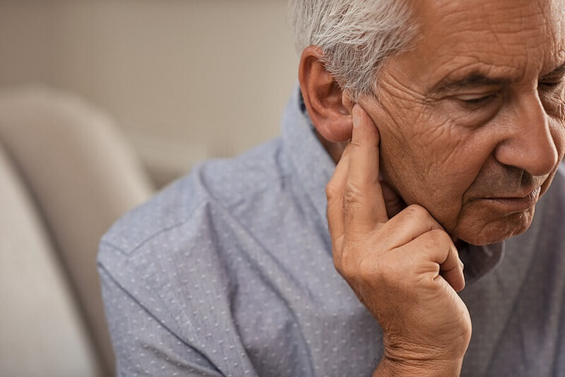 senior-man-holding-ear.jpg