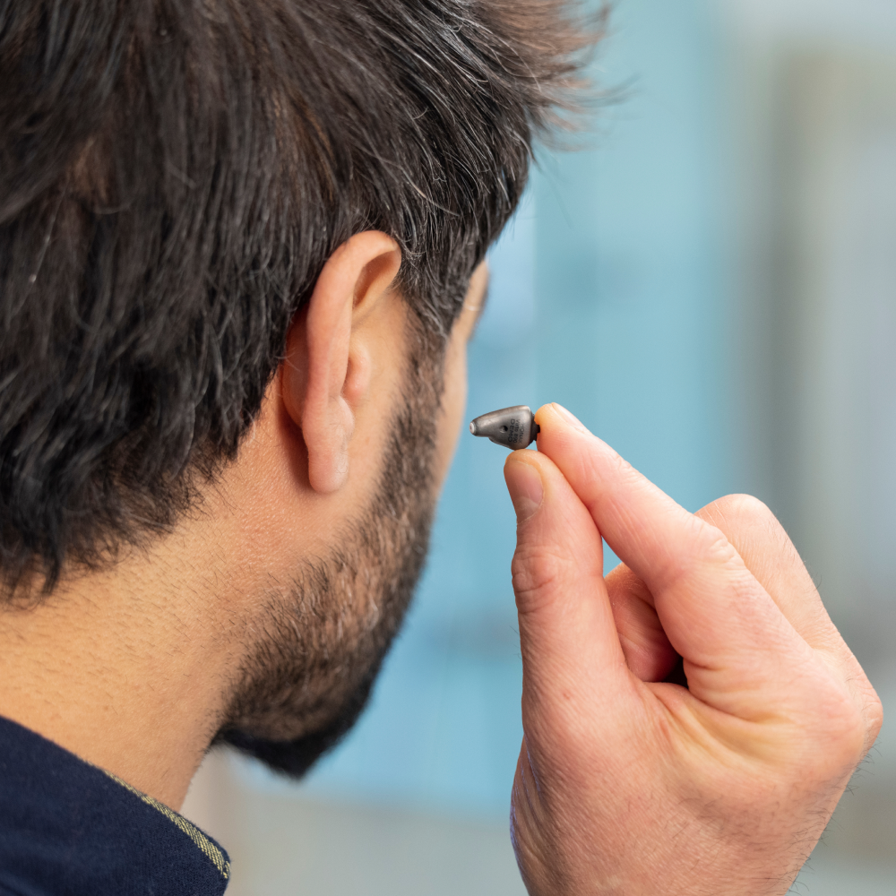 man-putting-in-earbud.png