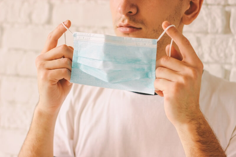 man-putting-face-mask-on.jpg