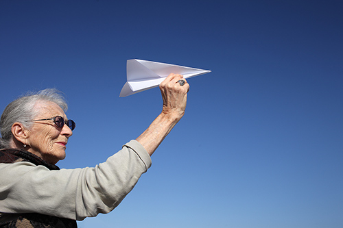 senior-woman-playing-with-pape-500.jpg