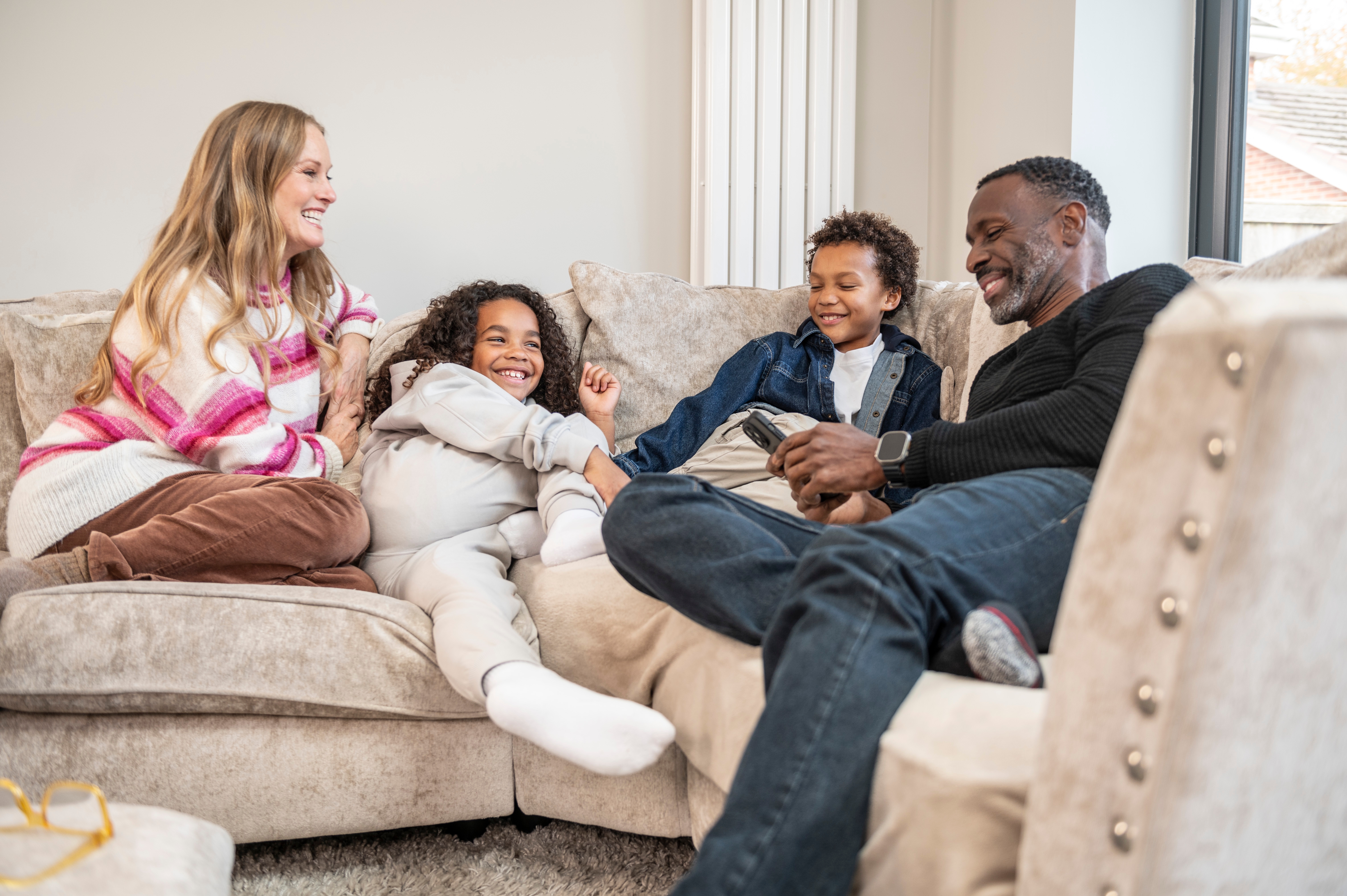 family-cudding-on-sofa.Jpg