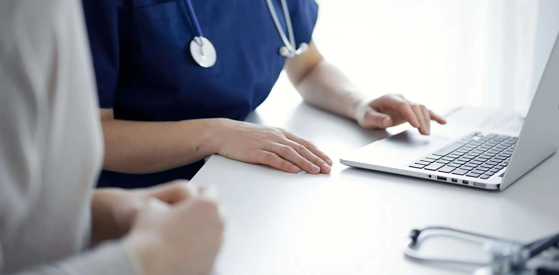 desktop banner 1821x896-Doctor-And-Patient-Sitting-478256977.jpg