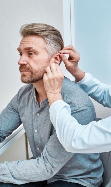 female-audiologist-fitting-hearing-aids.jpg
