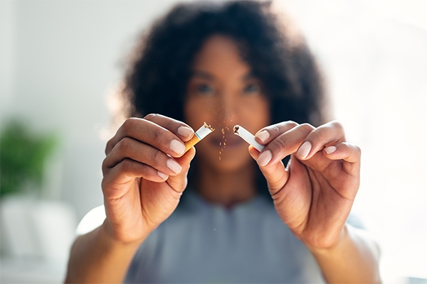 A woman quits smoking after learning of its effect on her hearing health. 