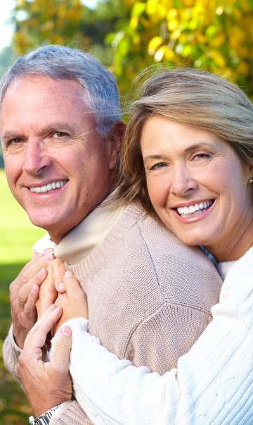senior-couple-hugging-nature.jpg