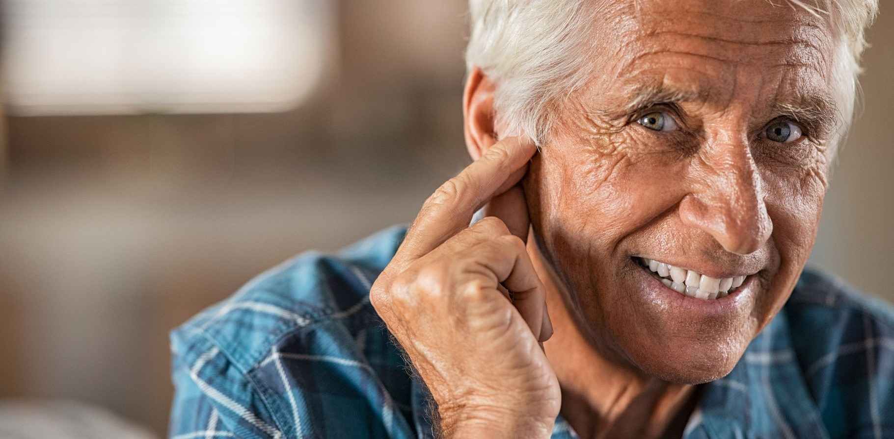 happy-man-at-home-with-hearing-aid.jpg