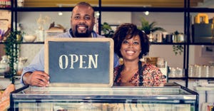 black business owners holding an open sign.jpg