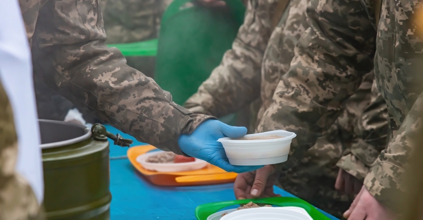 military meal being handed to troop.jpg