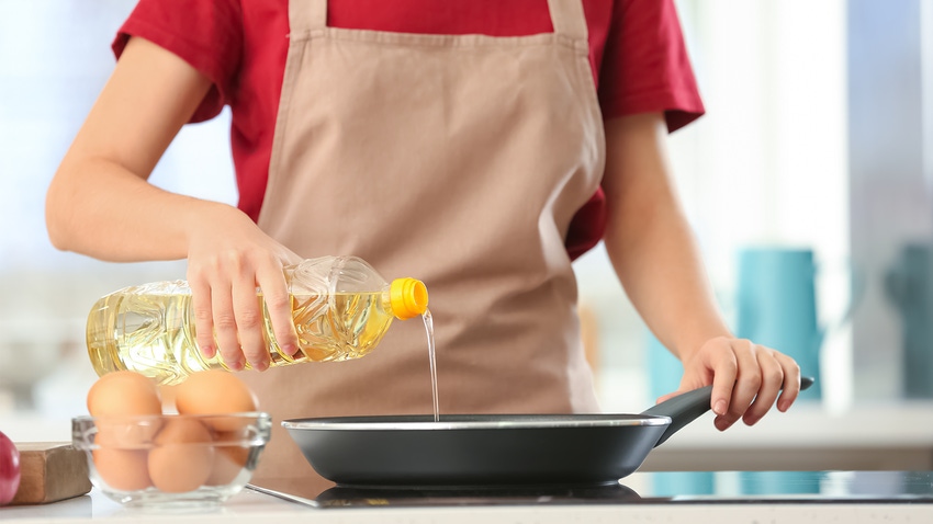 woman cooking with vegetable oil
