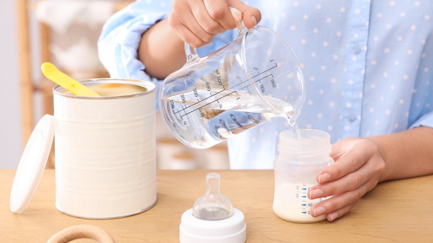 Woman mixing infant formula