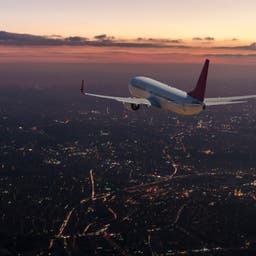 flugzeug-stadt-sonnenuntergang-g-1069089916.jpg