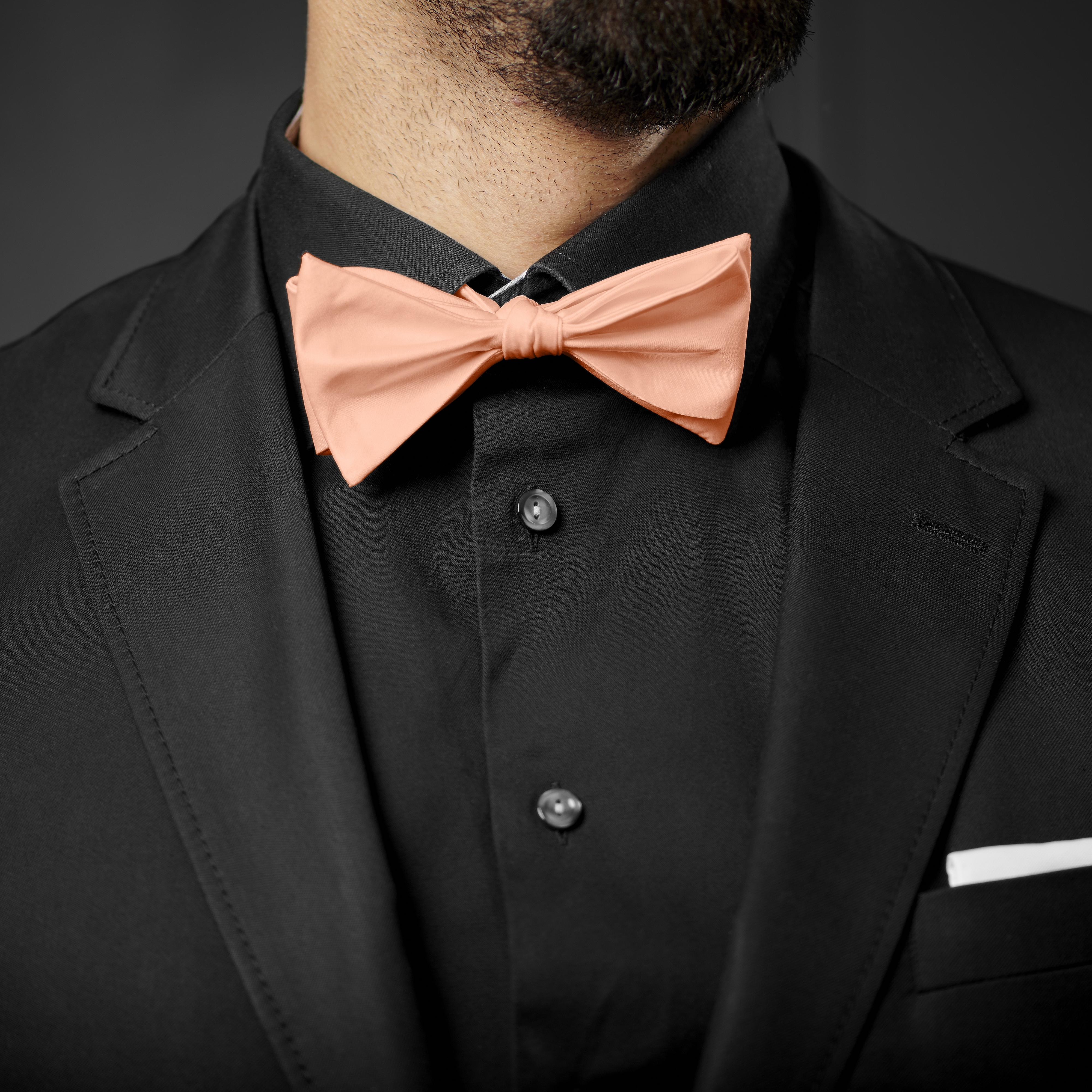 black dress shirt with pink bow tie