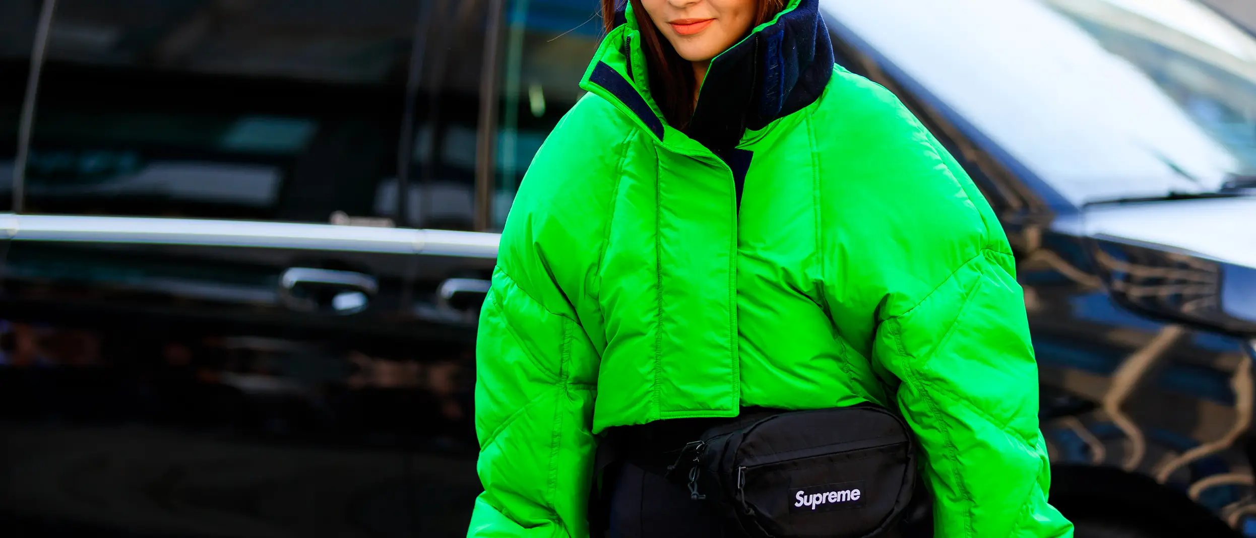 woman-walking-supreme-jacket-neon-green-coat-street-style-fashion-week.jpg