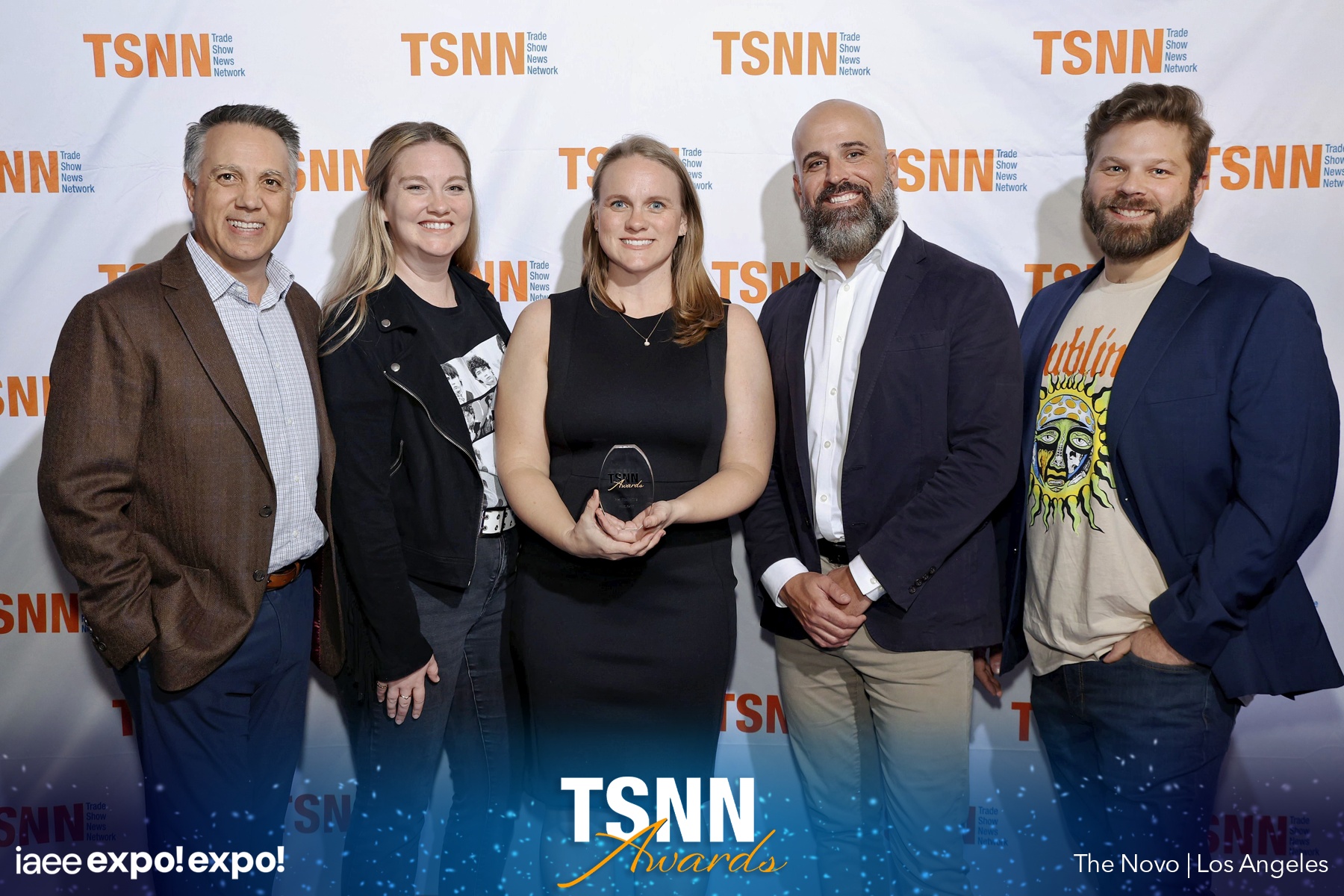 molly and team with award and tsnn backdrop.jpg