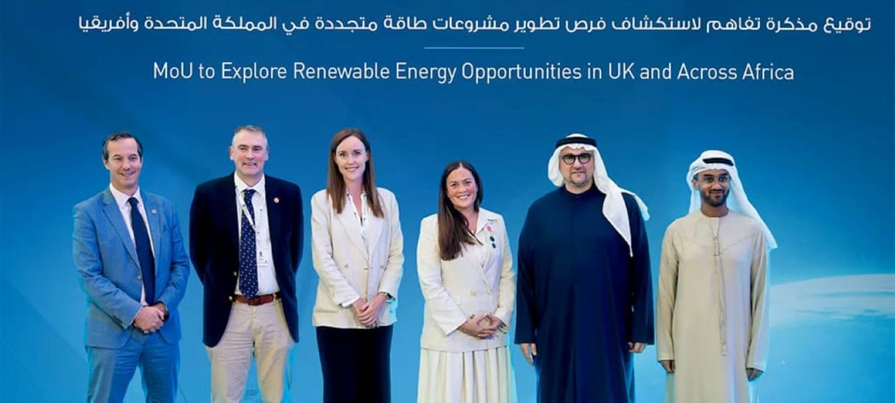 Company representatives smiling in front of a blue background