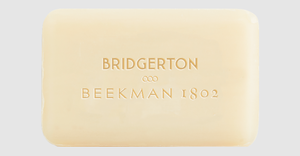 A bar of soap with the Beekman 1802 logo and the "Bridgerton" logo