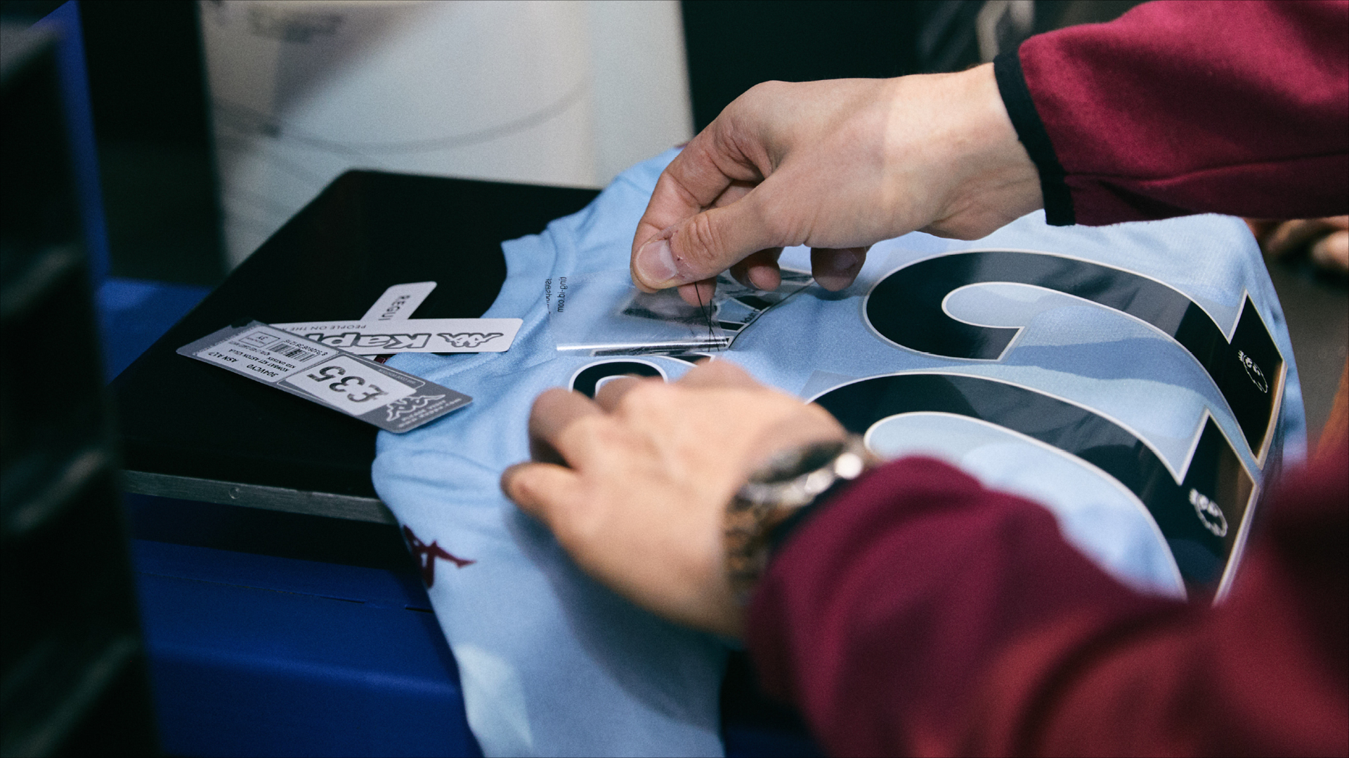 An Aston Villa F.C. replica away shirt during the manufacturing process, Fanatics
