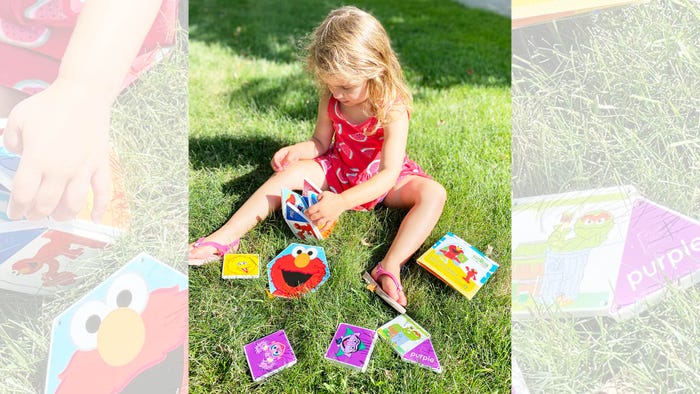 Child playing outdoors with Elmo tiles, CreateOn