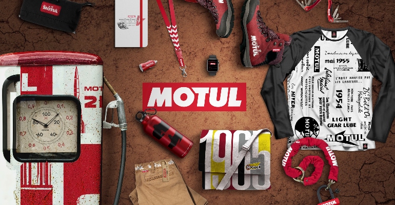 The Motul logo surrounded by branded products including t-shirts and lanyards