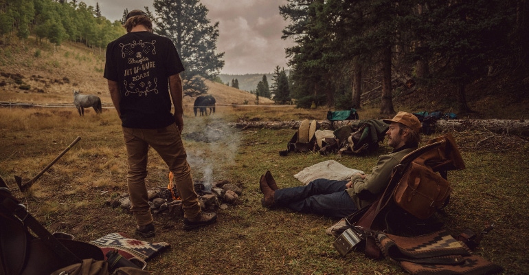 A promotional image for the 'Out of Range' collection from Wrangler and Roark