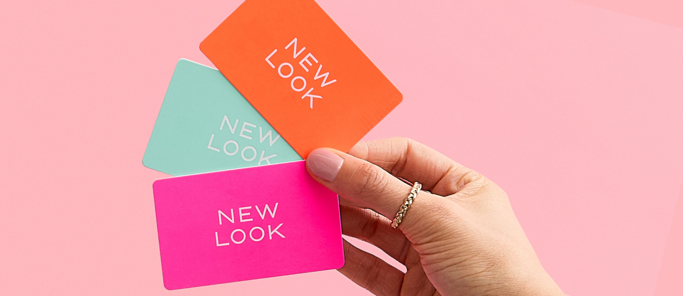 A hand displays four colourful gifts cards featuring the words "New Look" prominently.