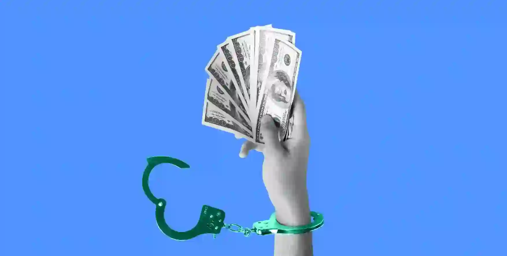 a hand in handcuffs holding cash