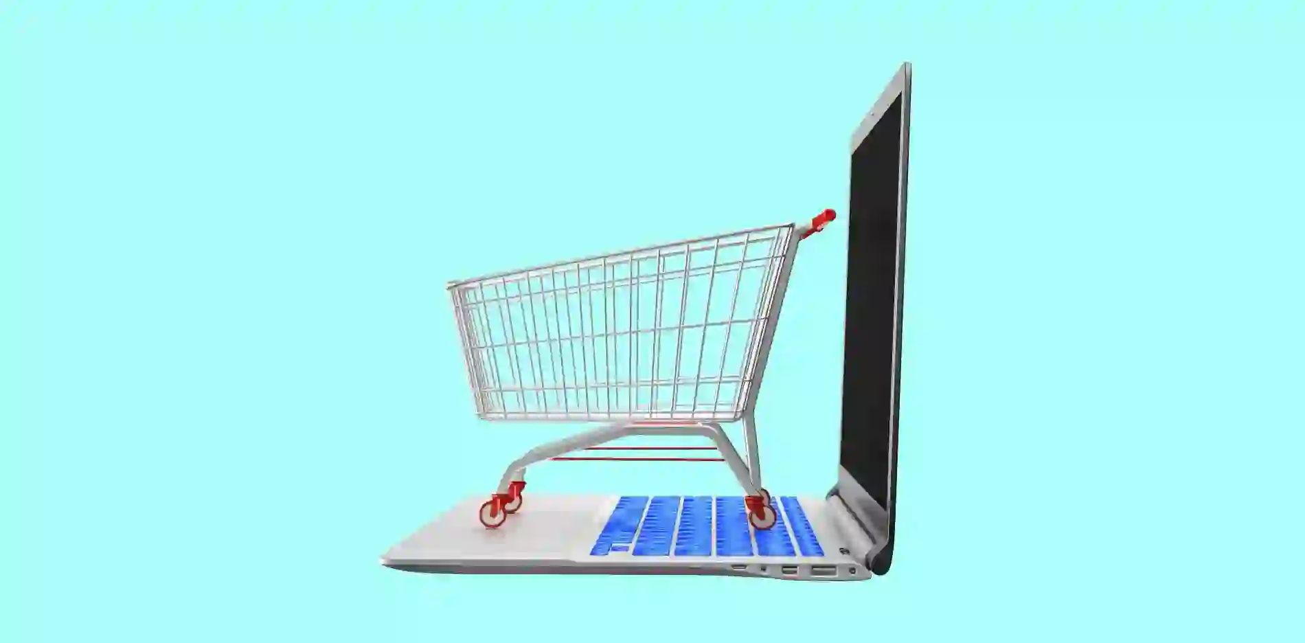 shopping cart stands on open laptop