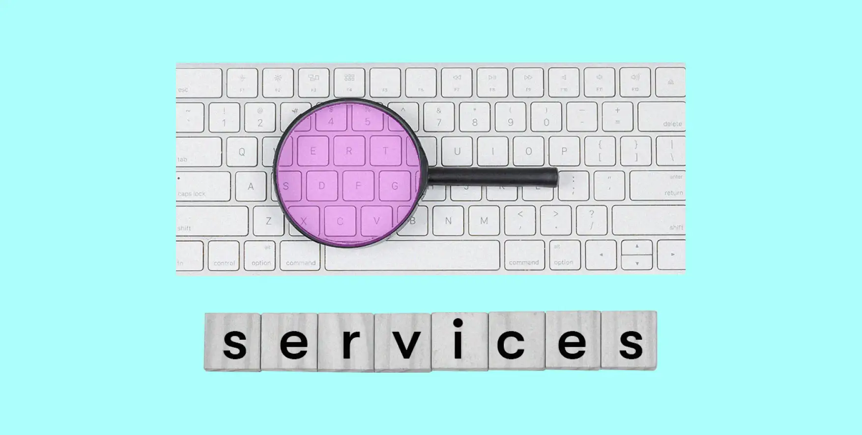 a magnifying glass lies on the keyboard, under which the word Services is written