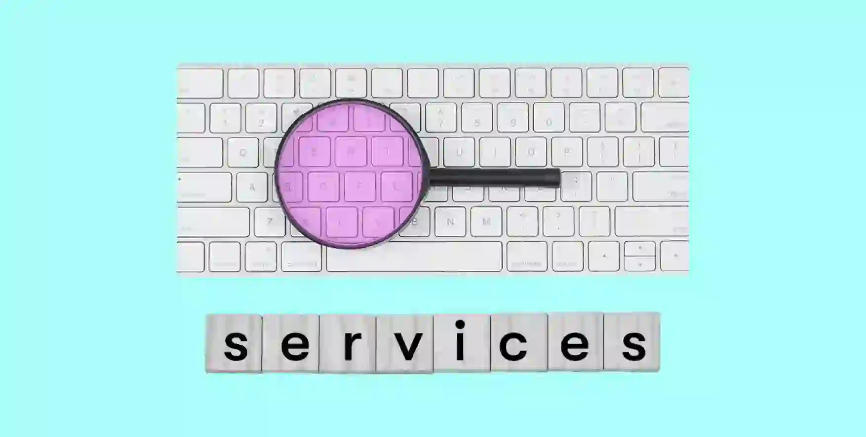 a magnifying glass lies on the keyboard, under which the word Services is written
