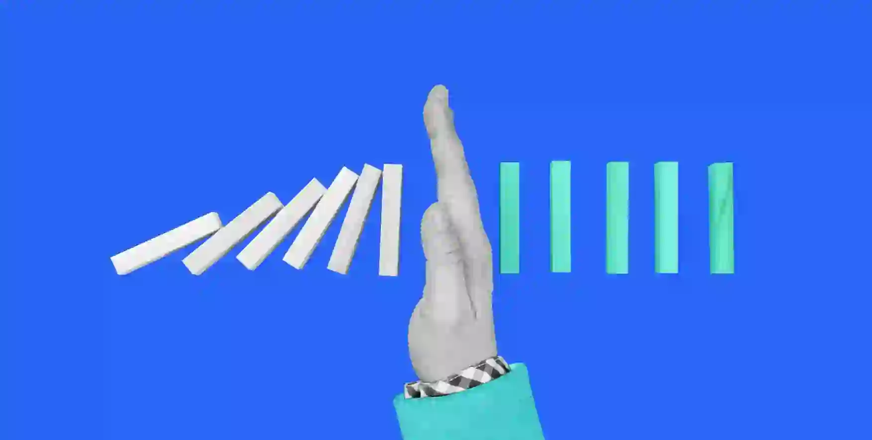 the hand is located between falling and standing dominoes