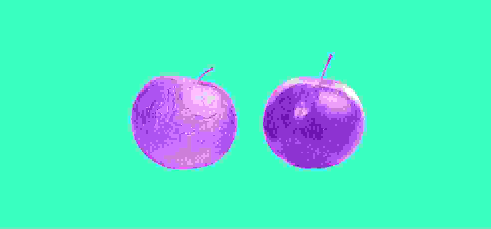 two apples on green background