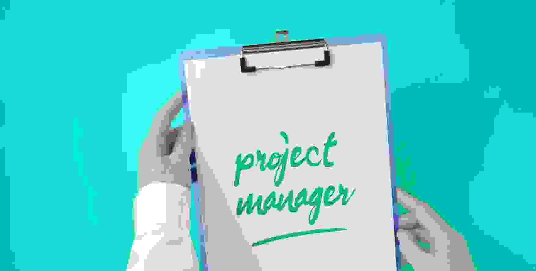project manager written on a piece of paper in a clipboard