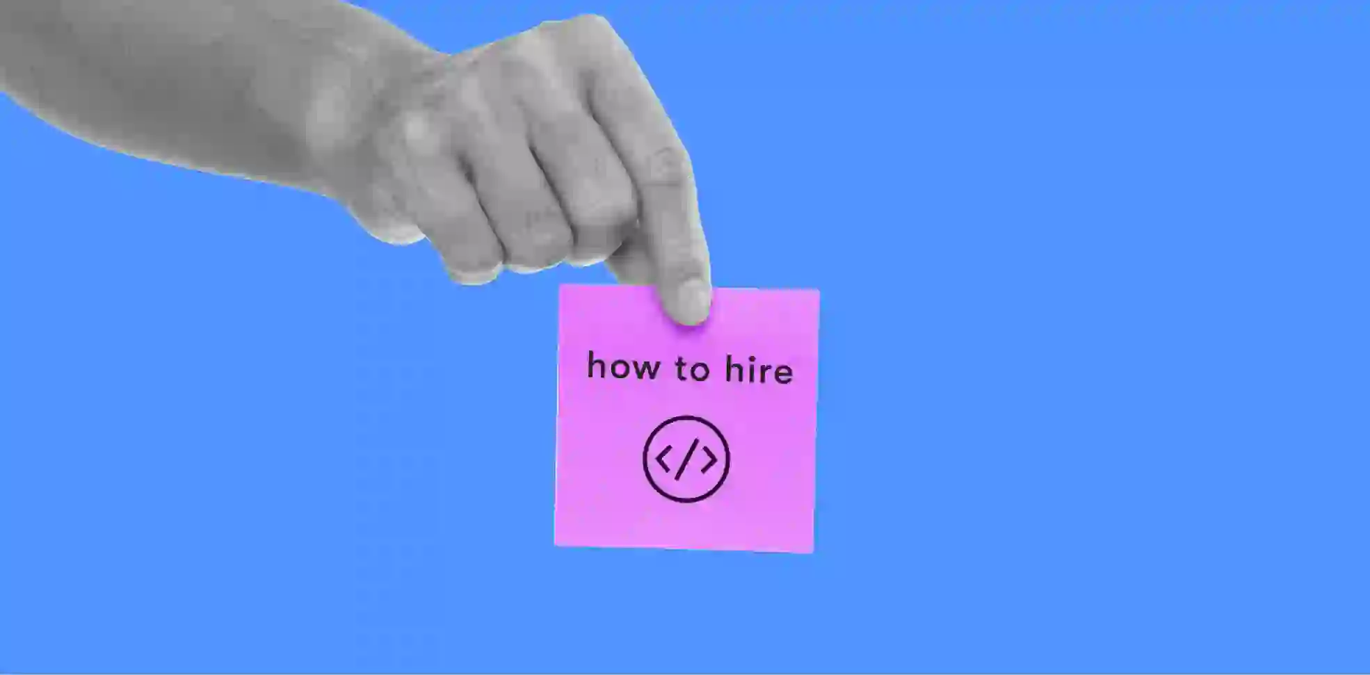 a hand holding a card with the inscription "how to hire"