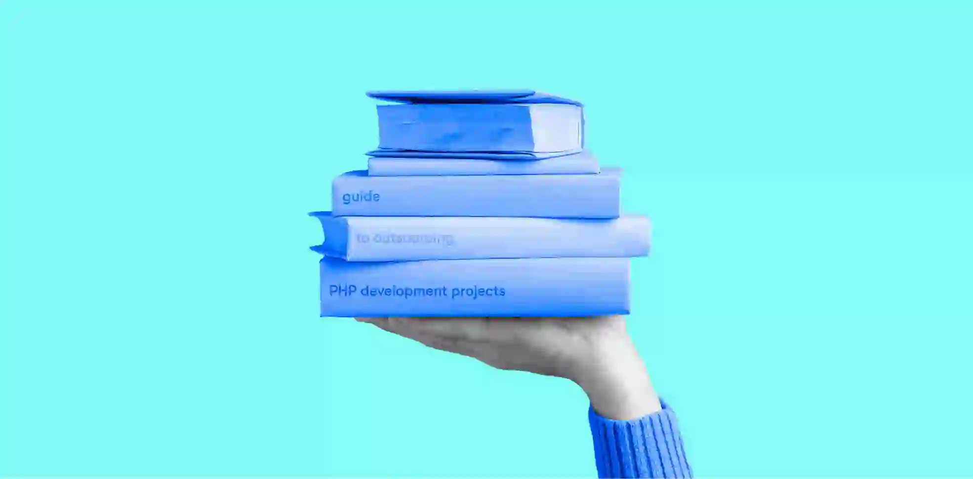 stack of books lies on a hand on blue background
