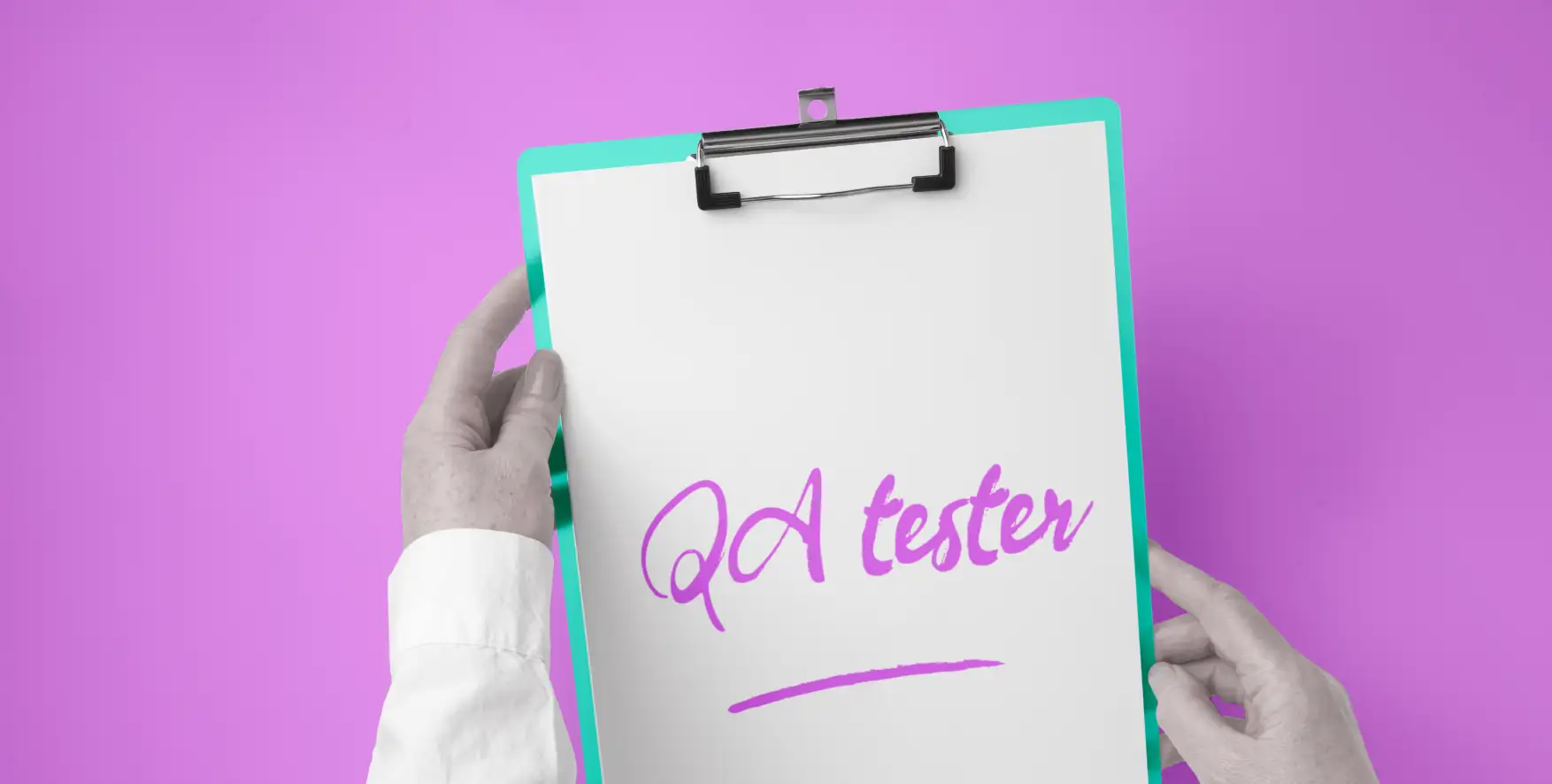 QA tester written on a piece of paper in a clipboard