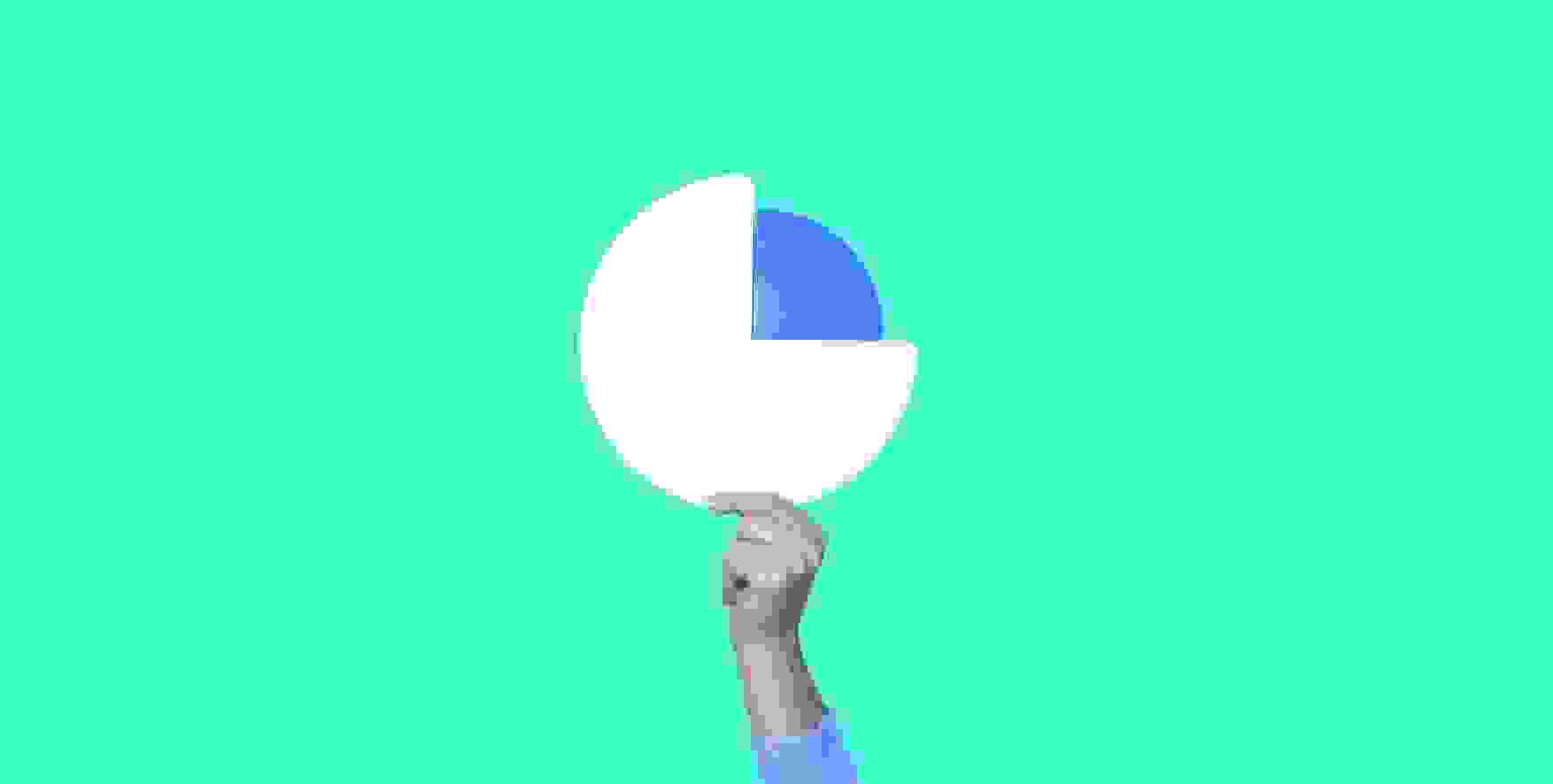 hand holds pie chart on green background