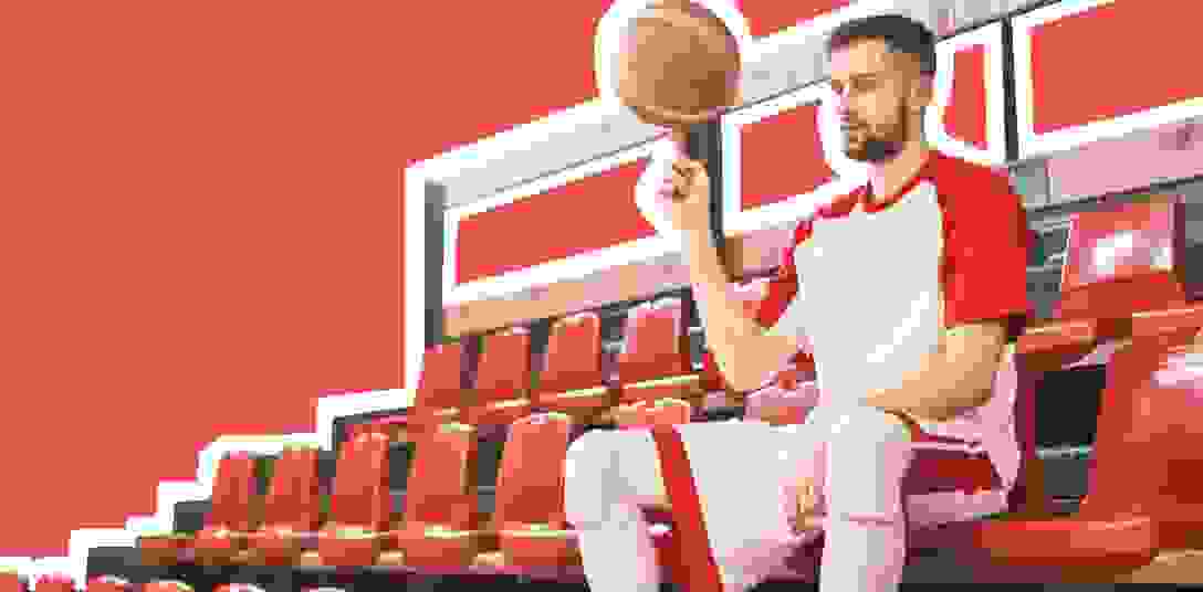 A basketball player sits on bench during the game