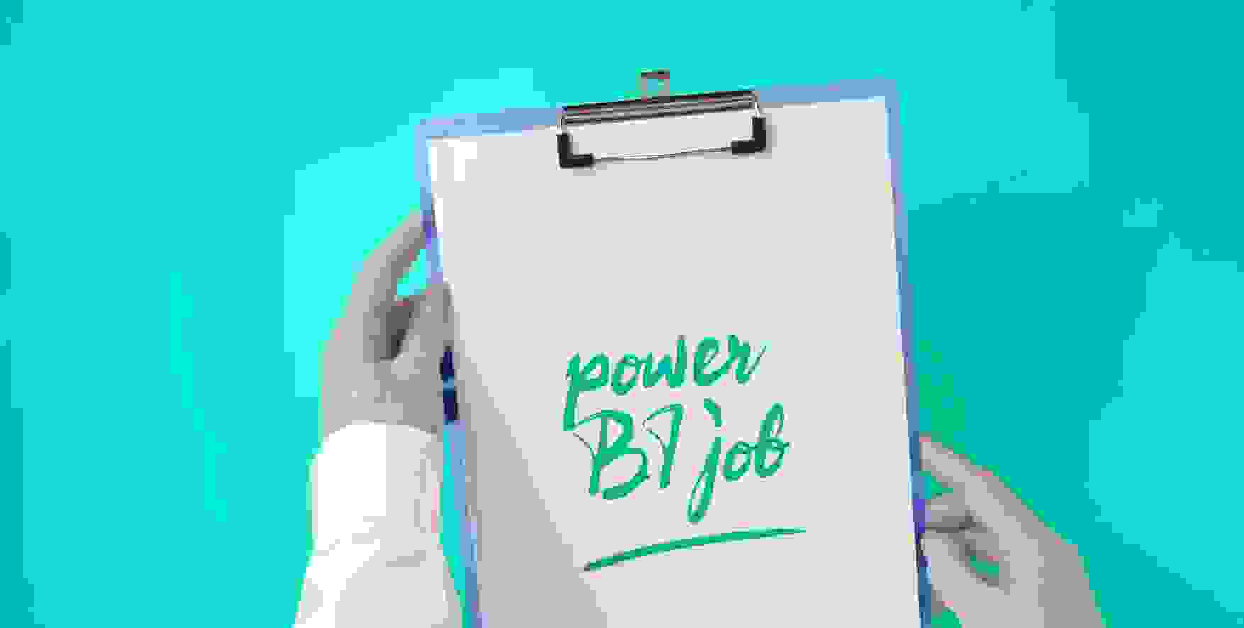 Power BI job written on a piece of paper in a clipboard