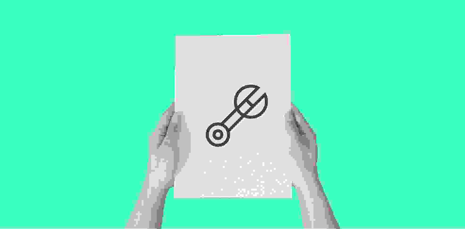 hands holding a sheet of paper with a wrench icon, on a green background