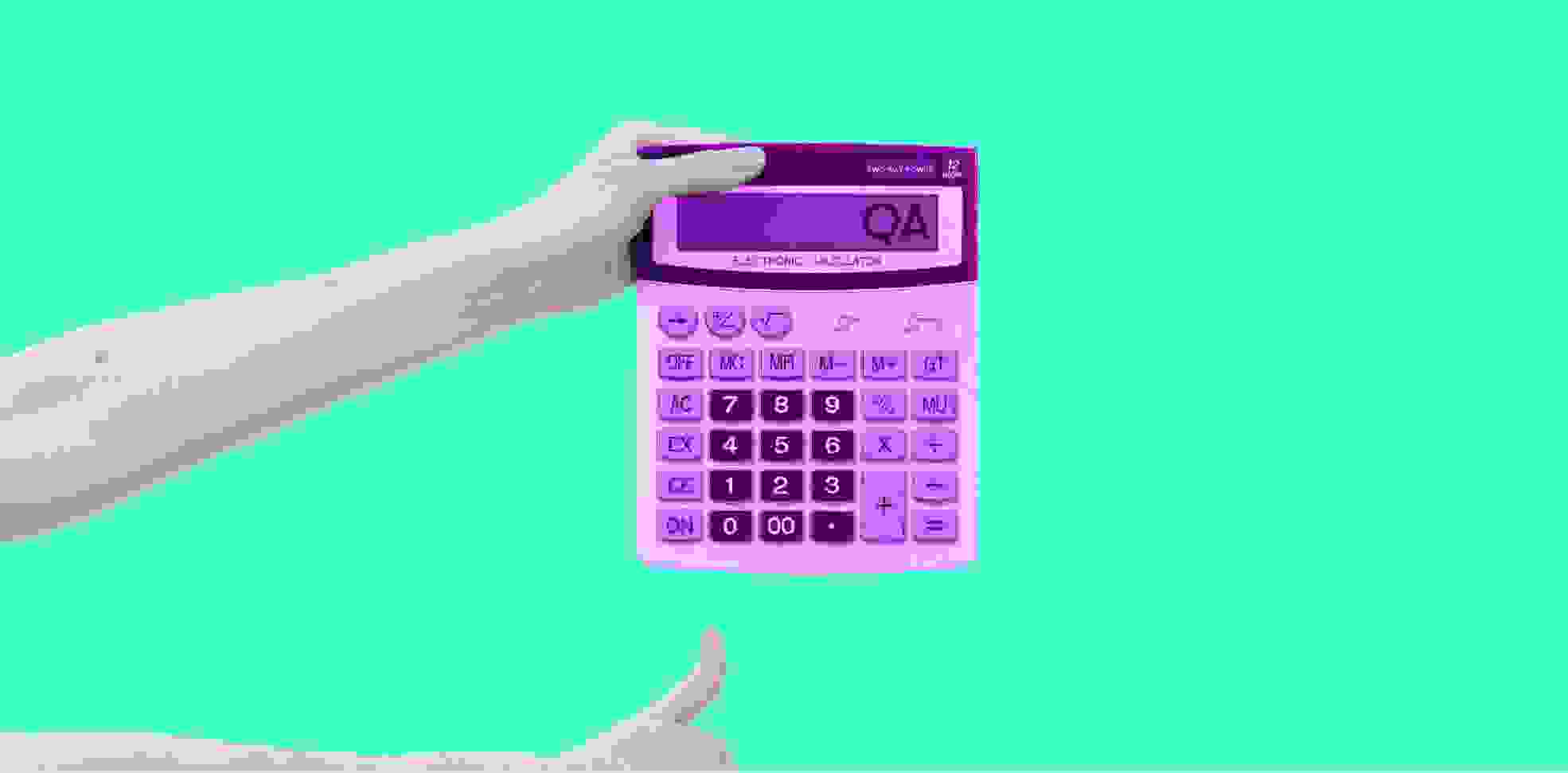 a hand holding a calculator