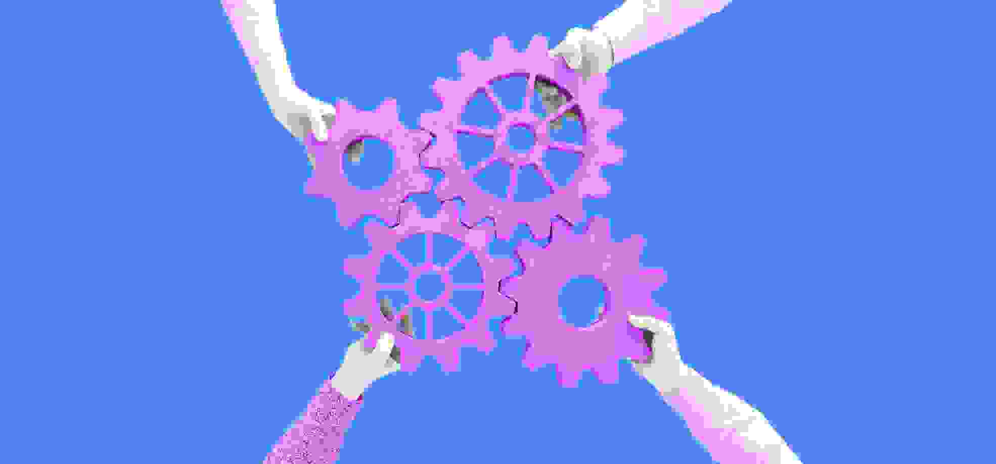 hands holding gears of different sizes