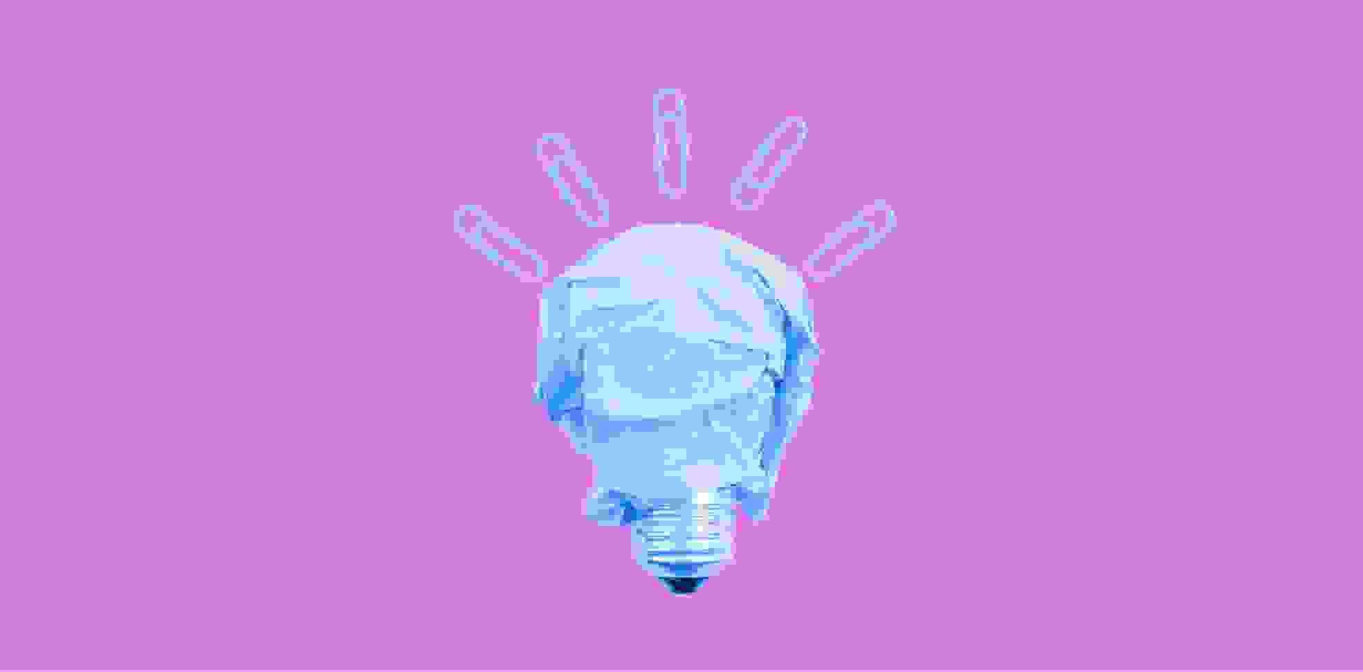 light bulb with paper clips on purple background
