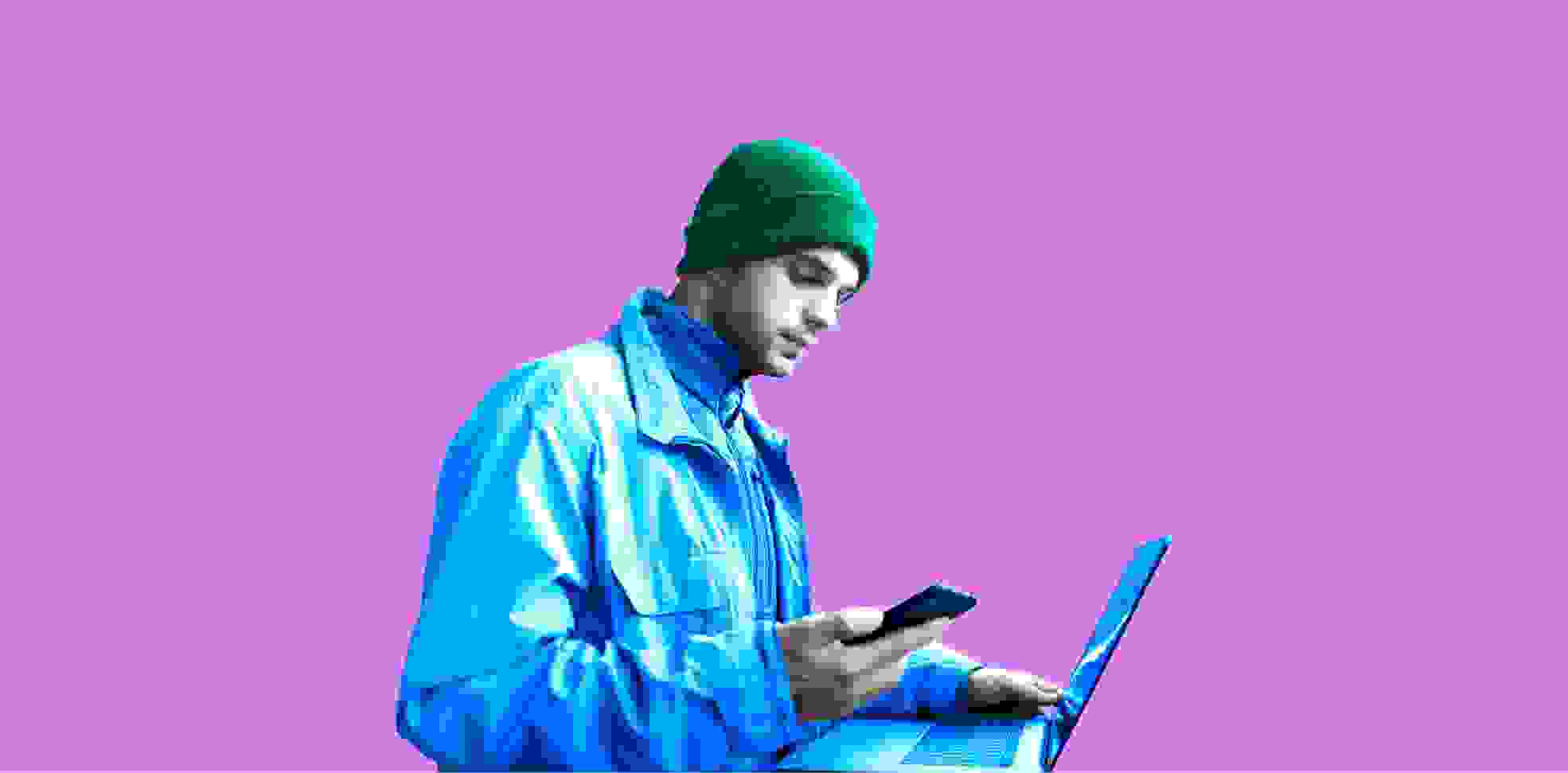 developer with a laptop and a phone on purple background