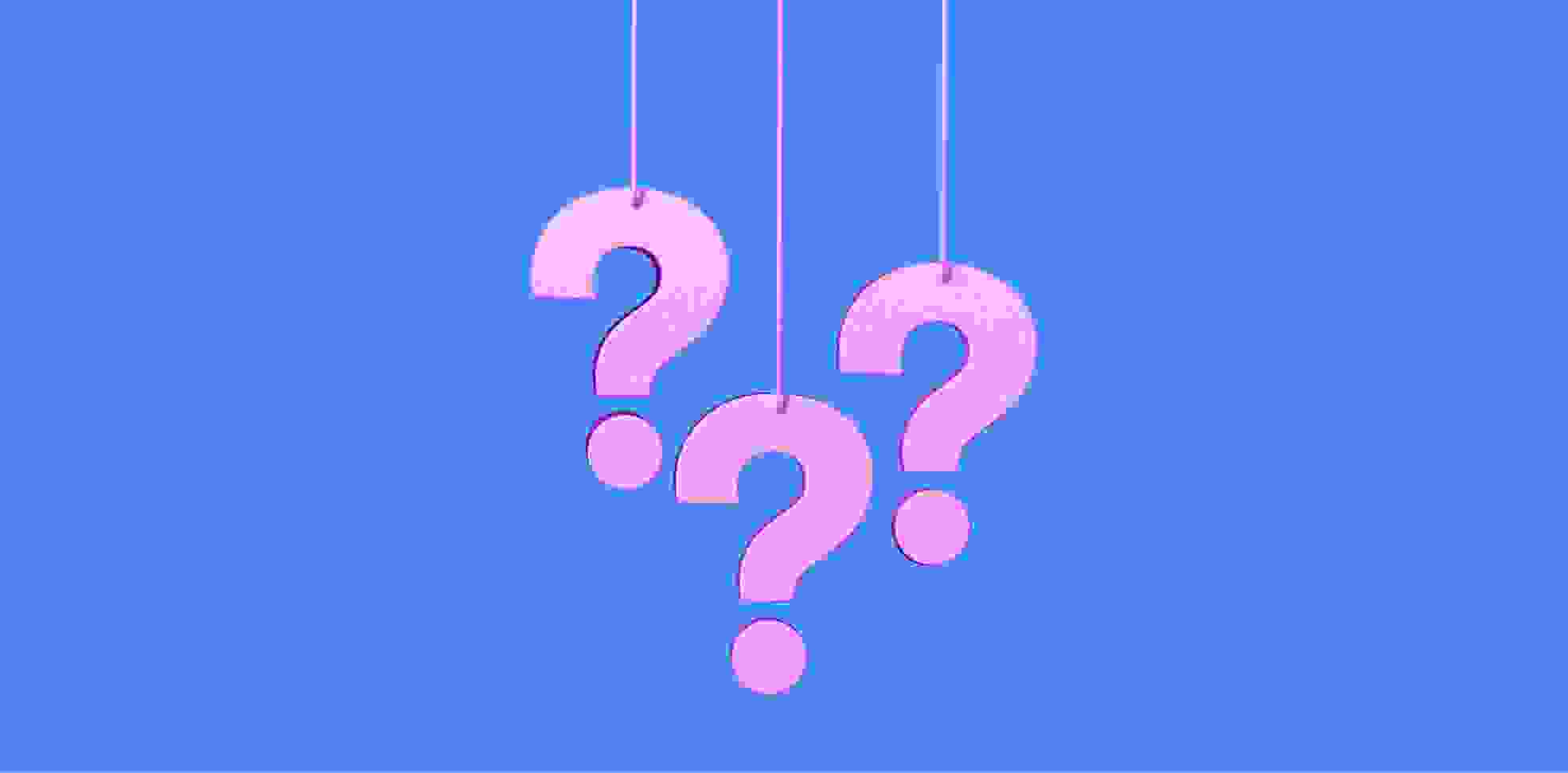 three question marks hanging on ropes