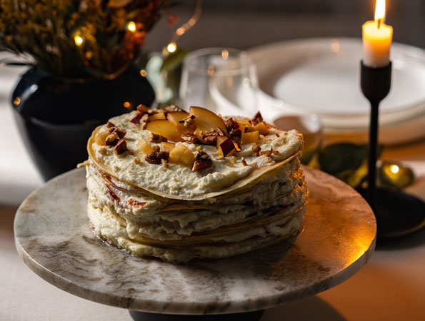 Crêpes cake with cream, plum jam & nuts